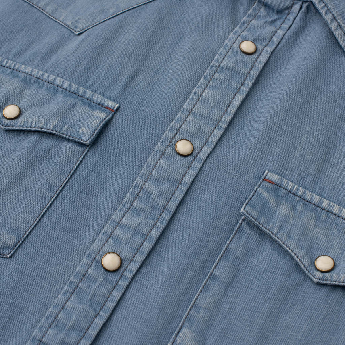 Close-up of men's Bisley Western shirt in solid blue with pearl snaps