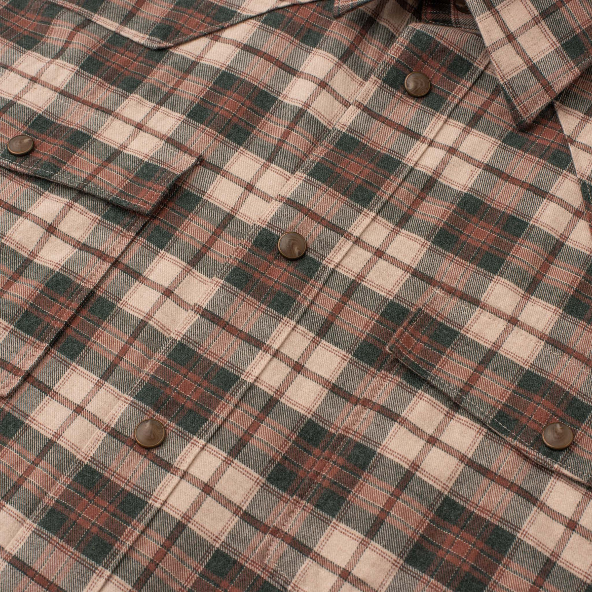 Close-up of men's Bisley Western shirt in ivory and green plaid with pearl snaps