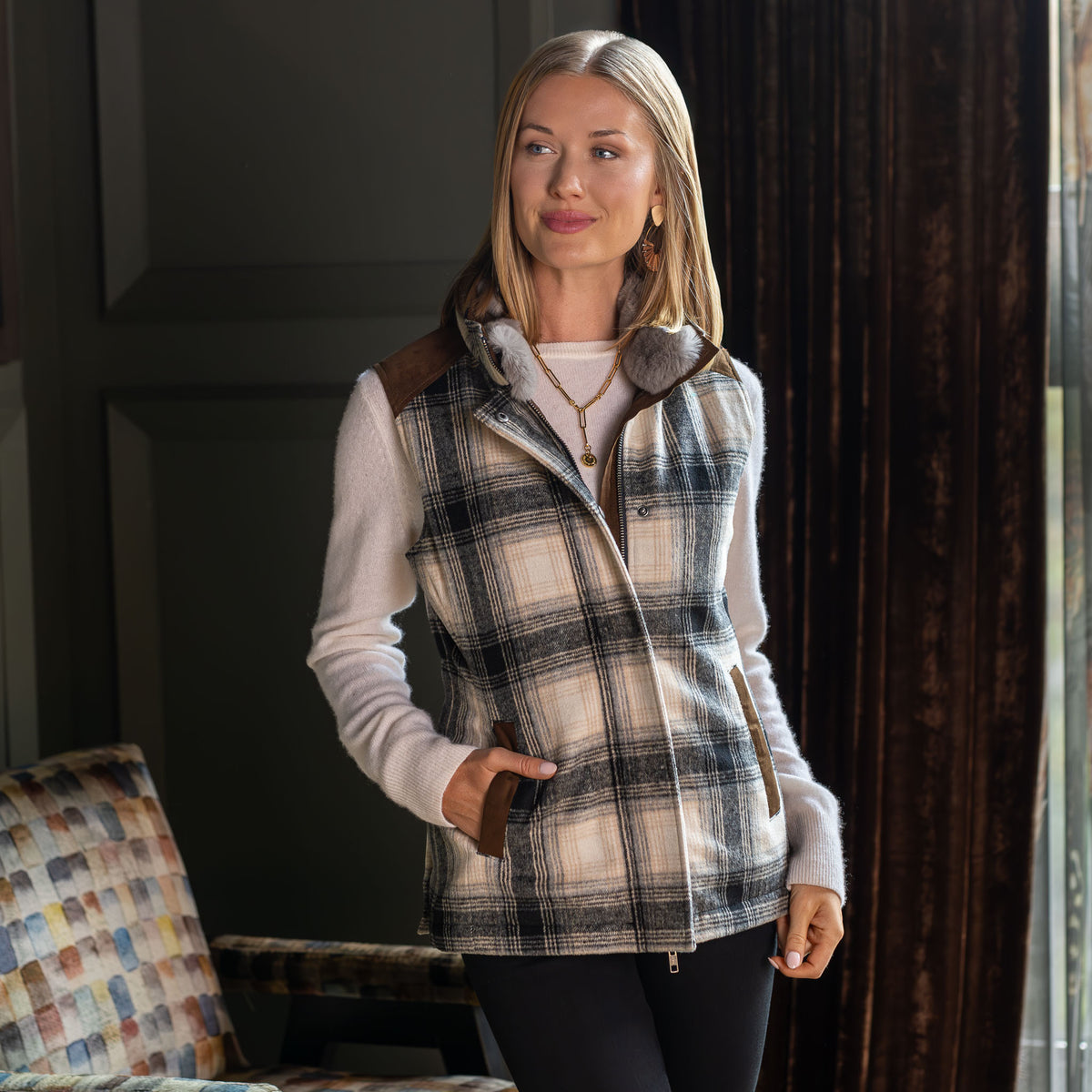 Model wearing the Cashiers wool blend vest with rabbit fur collar, zipped and snapped closed, front view.