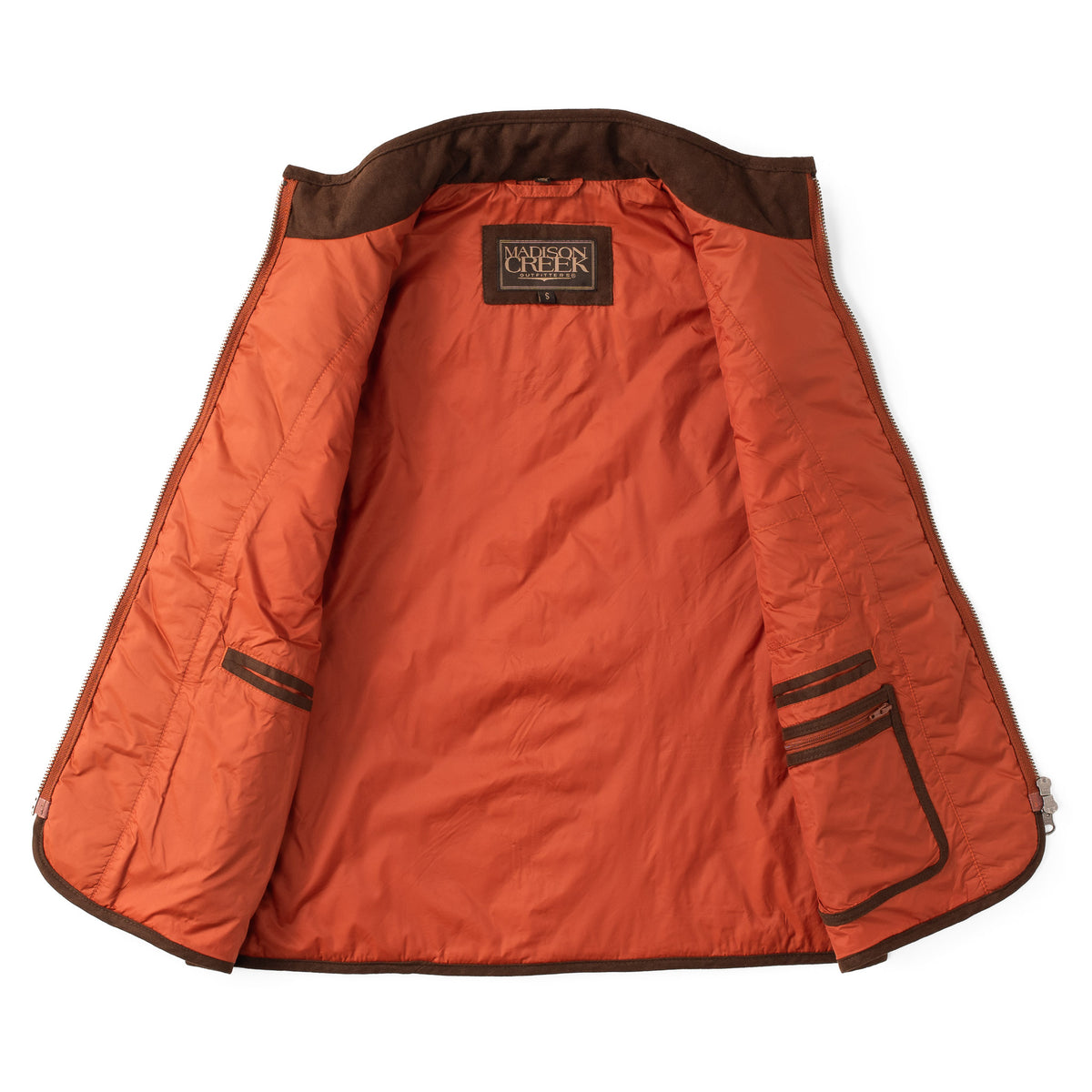 Interior view of the Ennis women’s quilted vest in copper, showing lining, interior pockets, and zippered storage pocket.