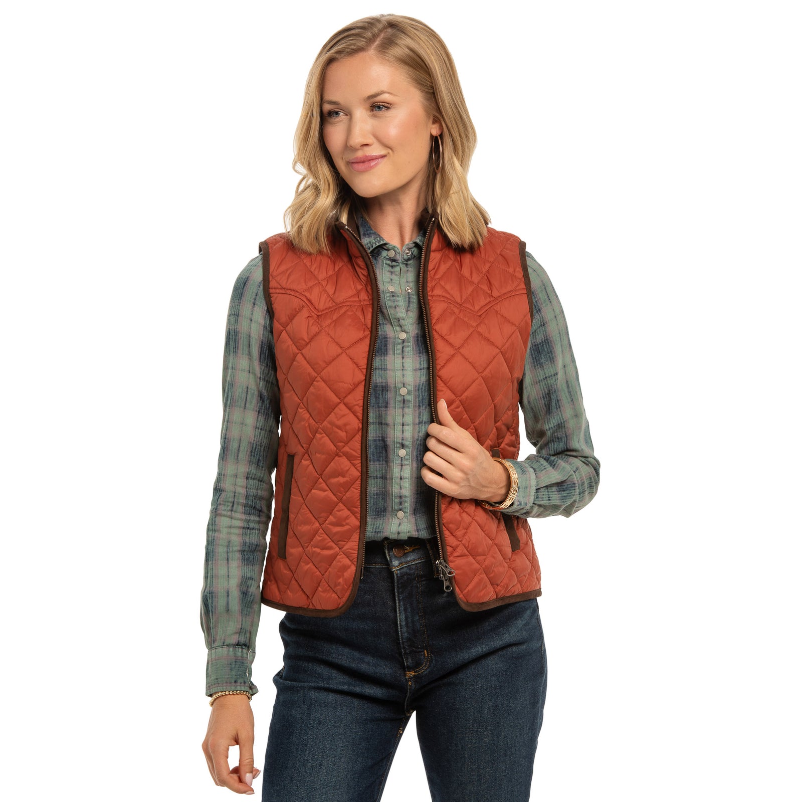 Model wearing women’s Ennis quilted nylon vest in copper, front view, unzipped.