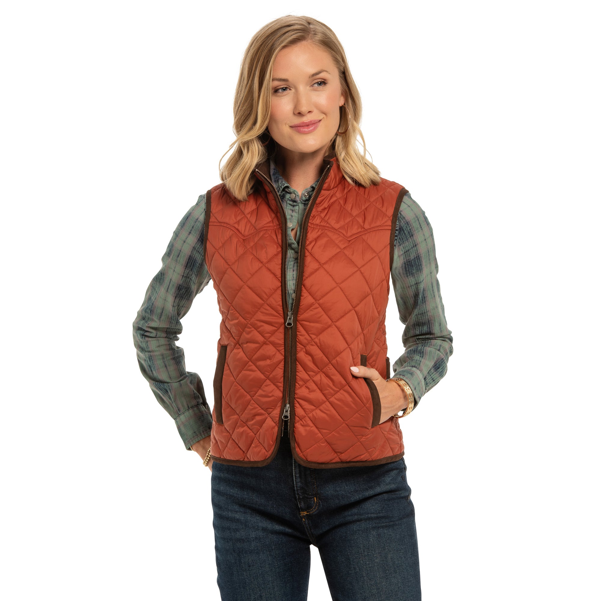 Model wearing women’s Ennis quilted nylon vest in copper, front view, unzipped.