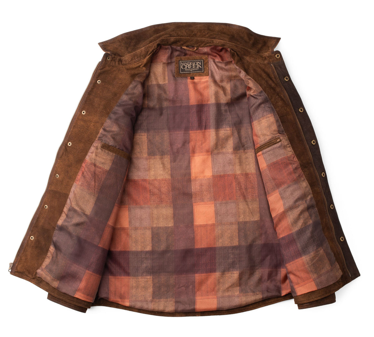 Interior view of the Franklin Waxed Goat Suede Quilted Jacket in Bourbon, showing Madison Creek‚Äôs signature ombr√© plaid lining and two interior storage pockets.